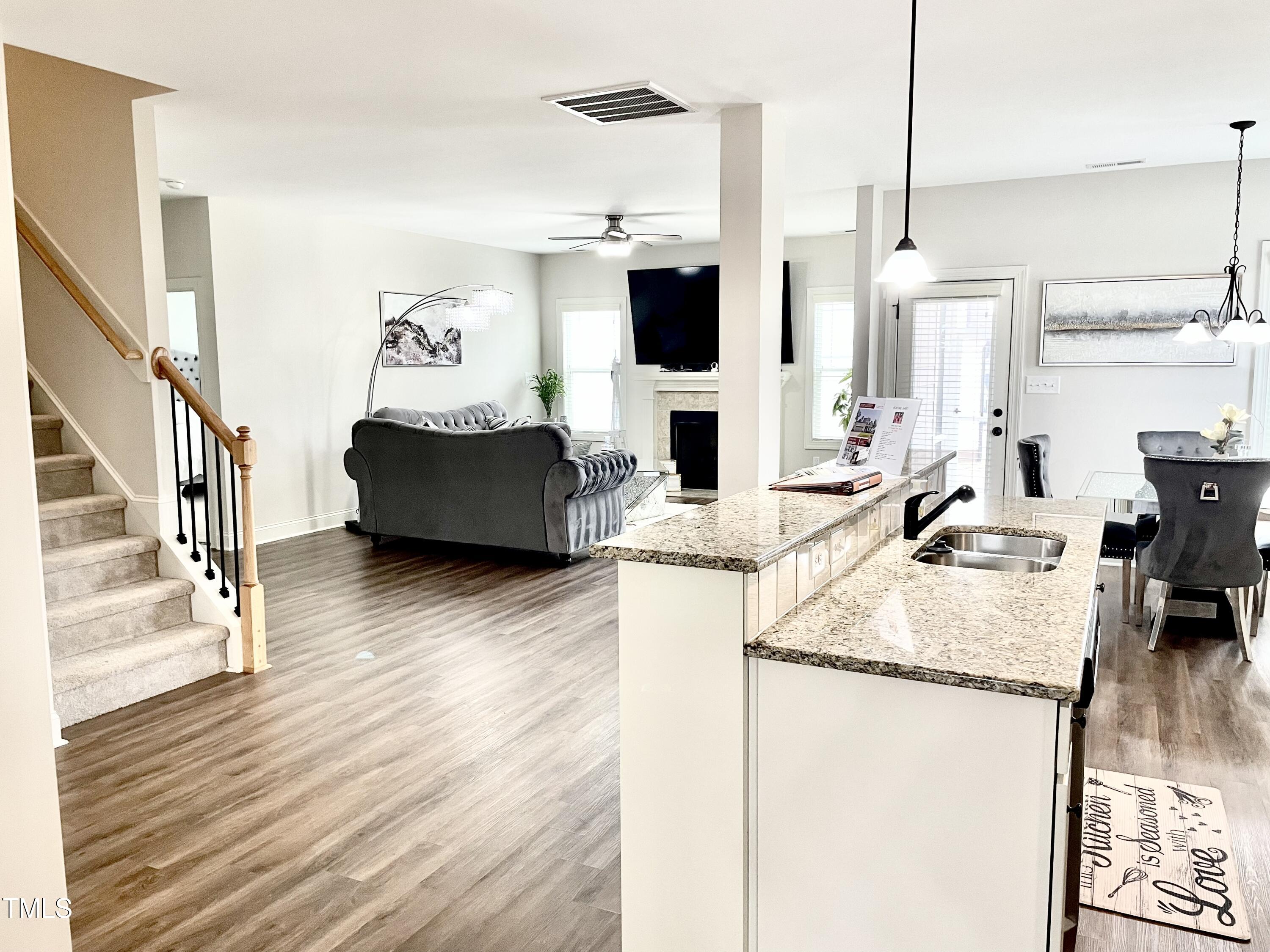 417 Airedale Trail Garner, NC 27529 - Photo 6 of 26 a living room with fireplace furniture and a wooden floor