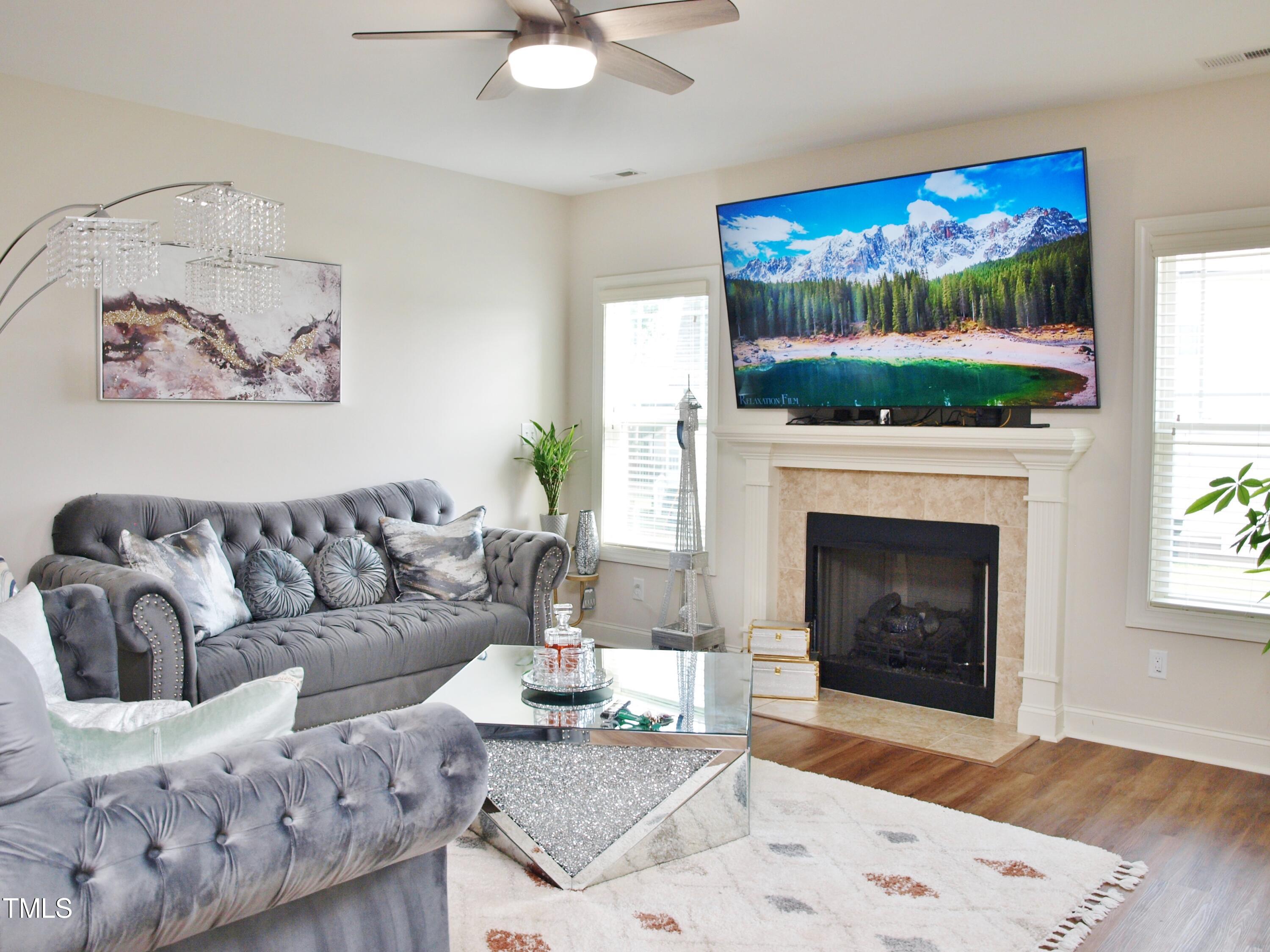417 Airedale Trail Garner, NC 27529 - Photo 7 of 26 a living room with furniture a fireplace and a flat screen tv