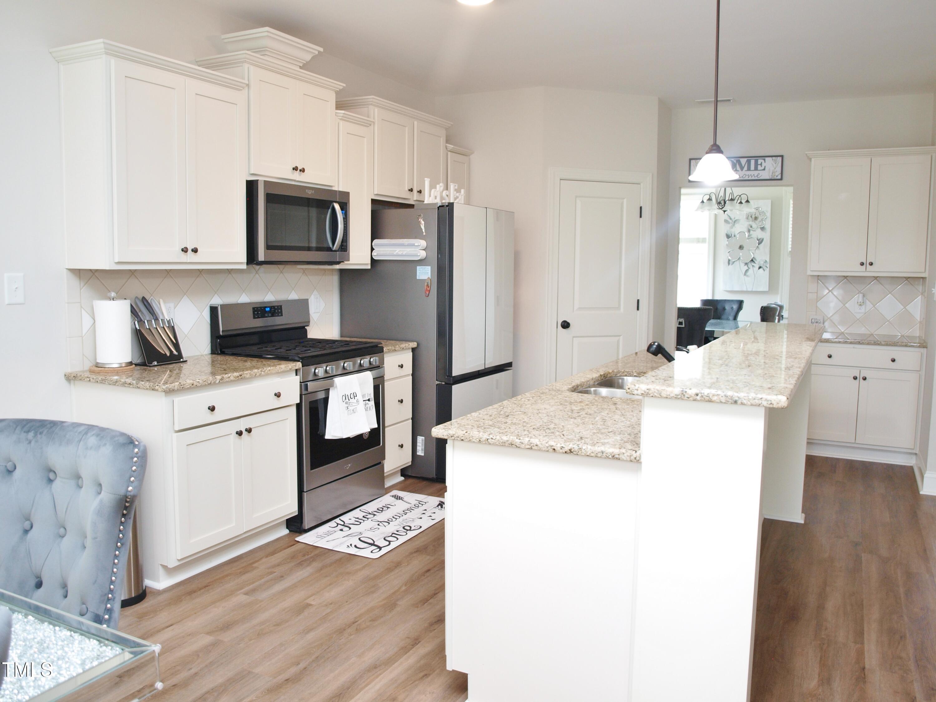 417 Airedale Trail Garner, NC 27529 - Photo 10 of 26 a kitchen with a sink stove and refrigerator