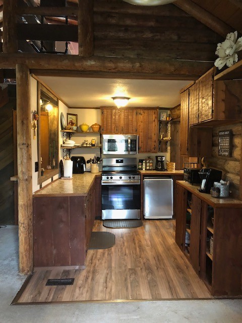 300 Roy Pitt Road Springfield, TN 37172 - Photo 18 of 26 a kitchen with stainless steel appliances granite countertop a stove a sink and a microwave