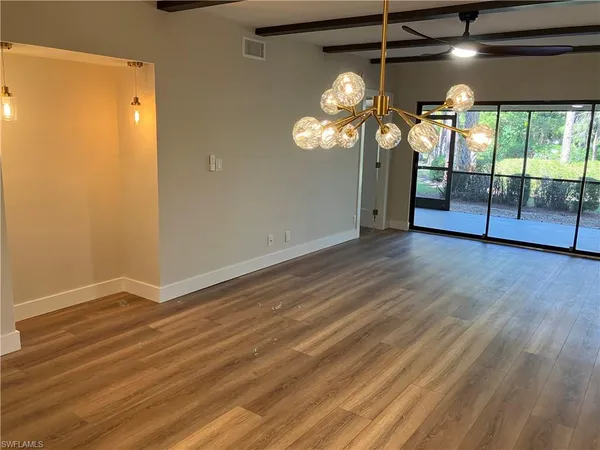 a view of a room with wooden floor