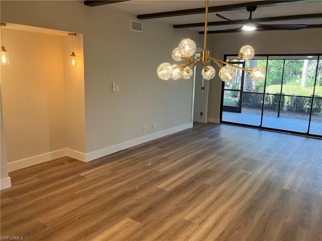 a view of a room with wooden floor