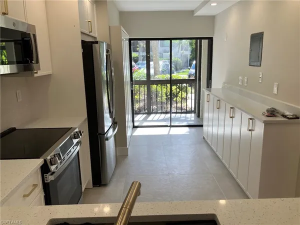 a view of a kitchen with an empty space and a window