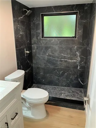 a bathroom with a toilet and a shower