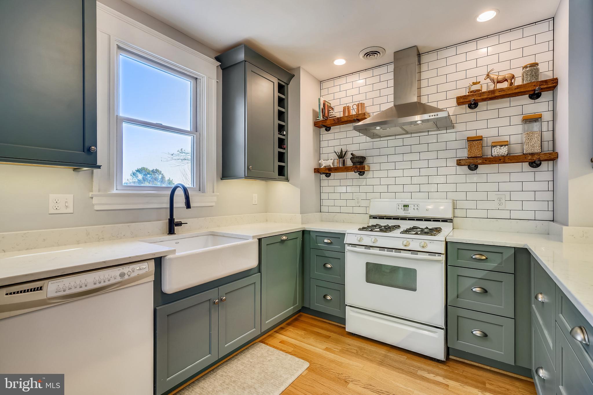 910 Overbrook Road Baltimore, MD 21239 - Photo 17 of 50 a kitchen with a sink stove and cabinets