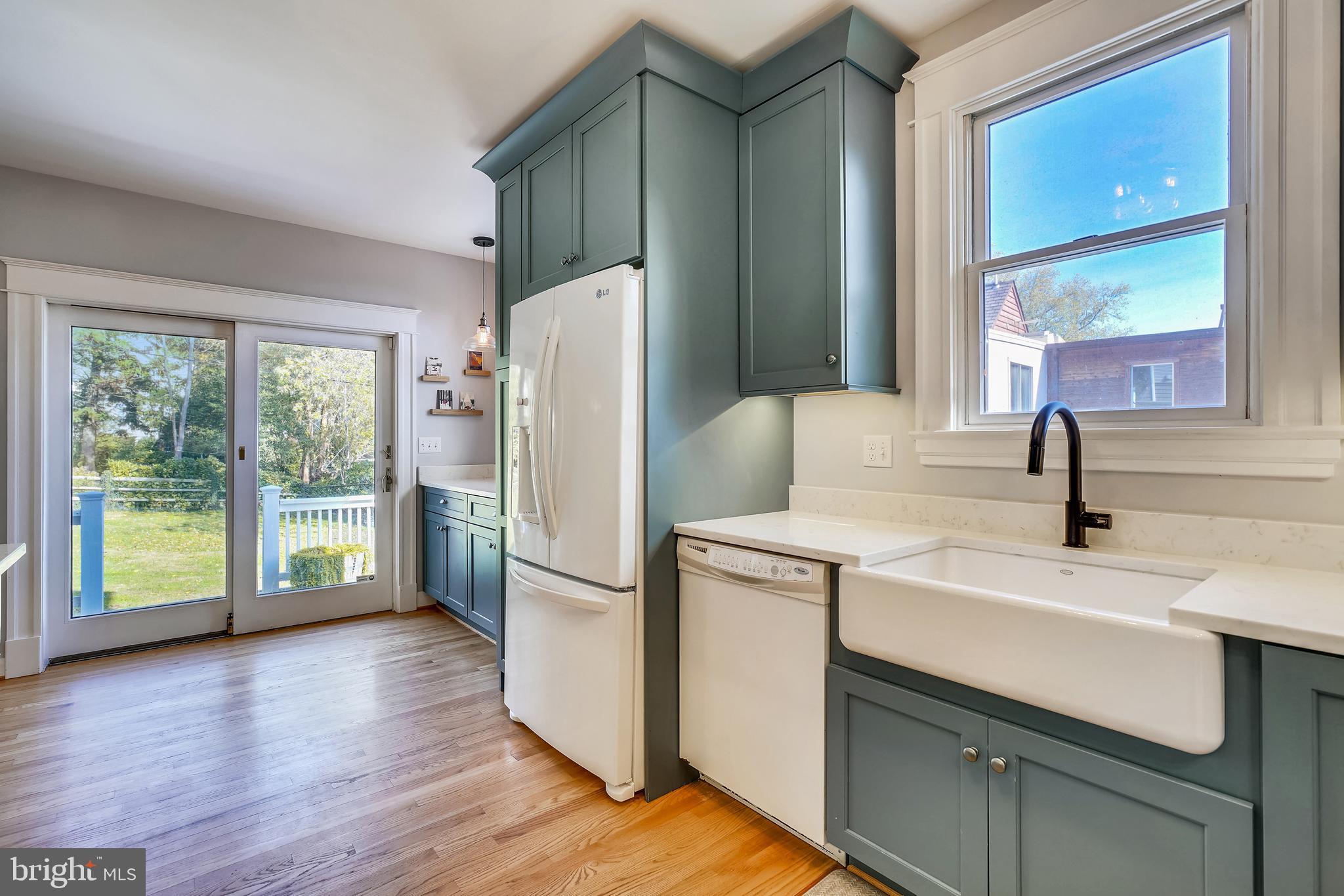 910 Overbrook Road Baltimore, MD 21239 - Photo 19 of 50 a kitchen with a refrigerator a sink and a large window