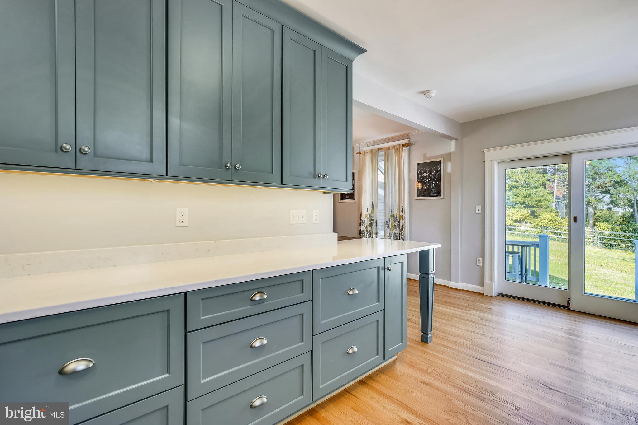 910 Overbrook Road Baltimore, MD 21239 - Photo 20 of 50 a kitchen with wood cabinets and wooden floors