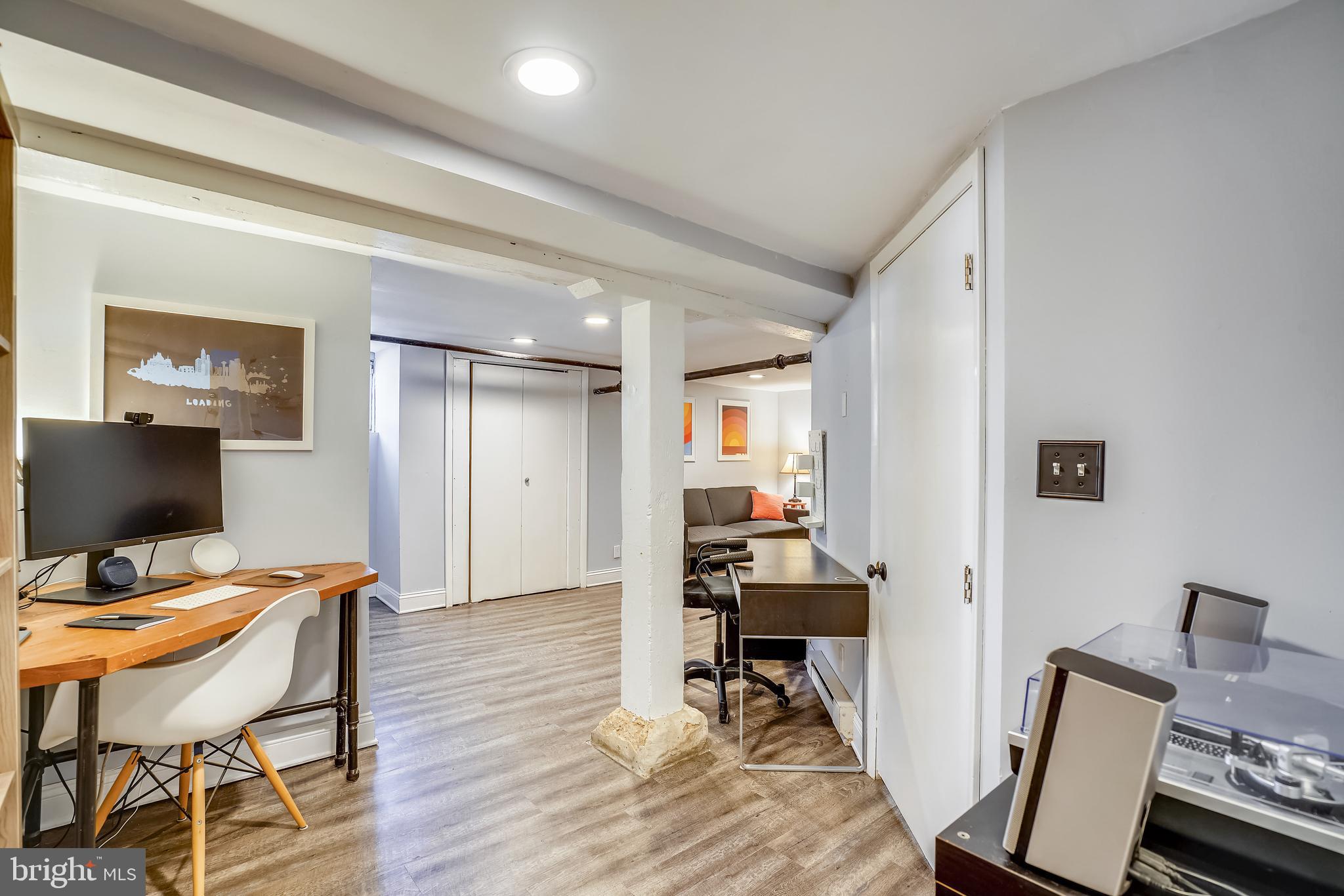 910 Overbrook Road Baltimore, MD 21239 - Photo 30 of 50 a workspace with furniture and wooden floor