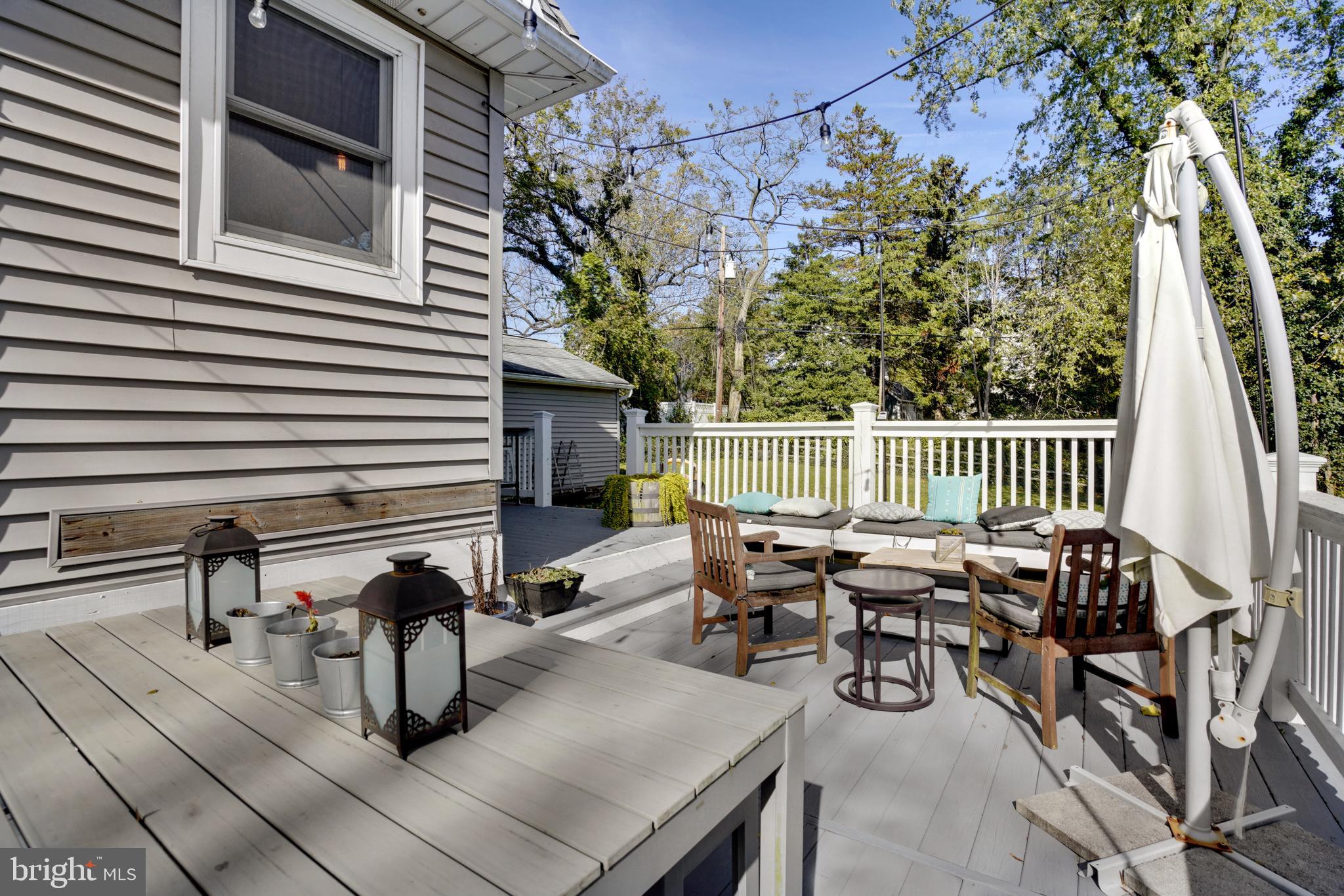 910 Overbrook Road Baltimore, MD 21239 - Photo 33 of 50 a roof deck with table and chairs and potted plants
