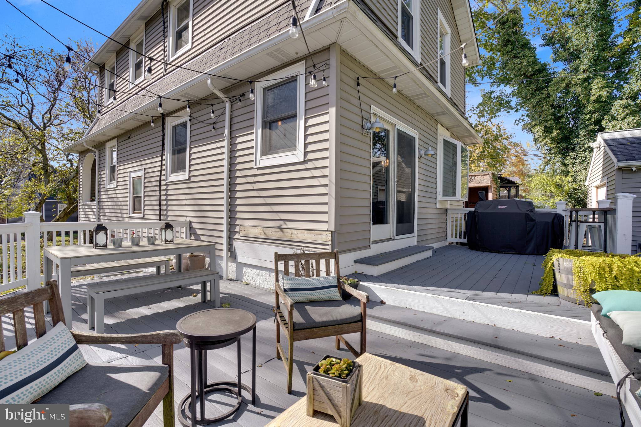 910 Overbrook Road Baltimore, MD 21239 - Photo 5 of 50 a view of a patio with couches table and chairs with wooden floor and fence