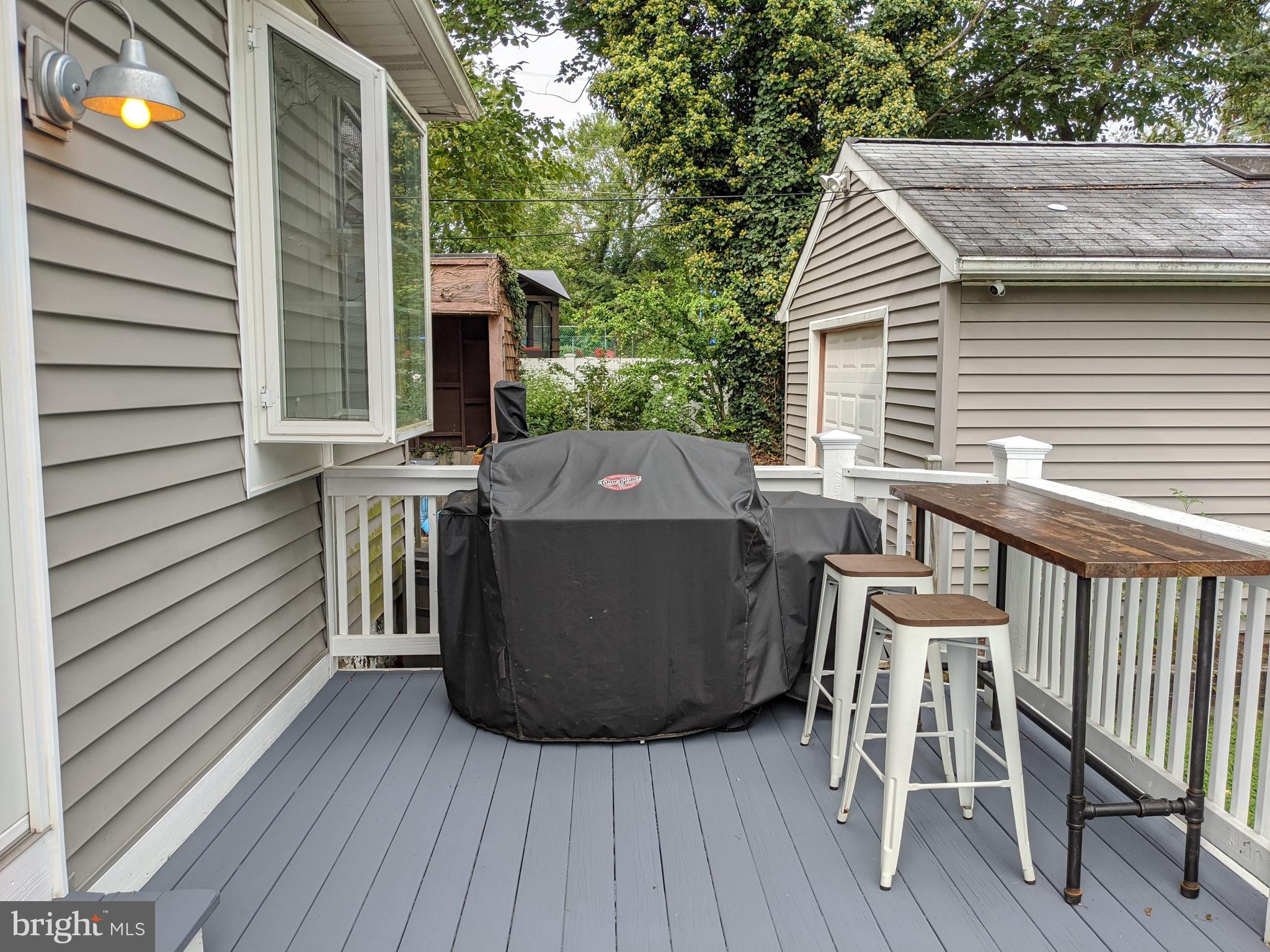 910 Overbrook Road Baltimore, MD 21239 - Photo 48 of 50 a view of a deck with table and chairs with wooden floor and fence
