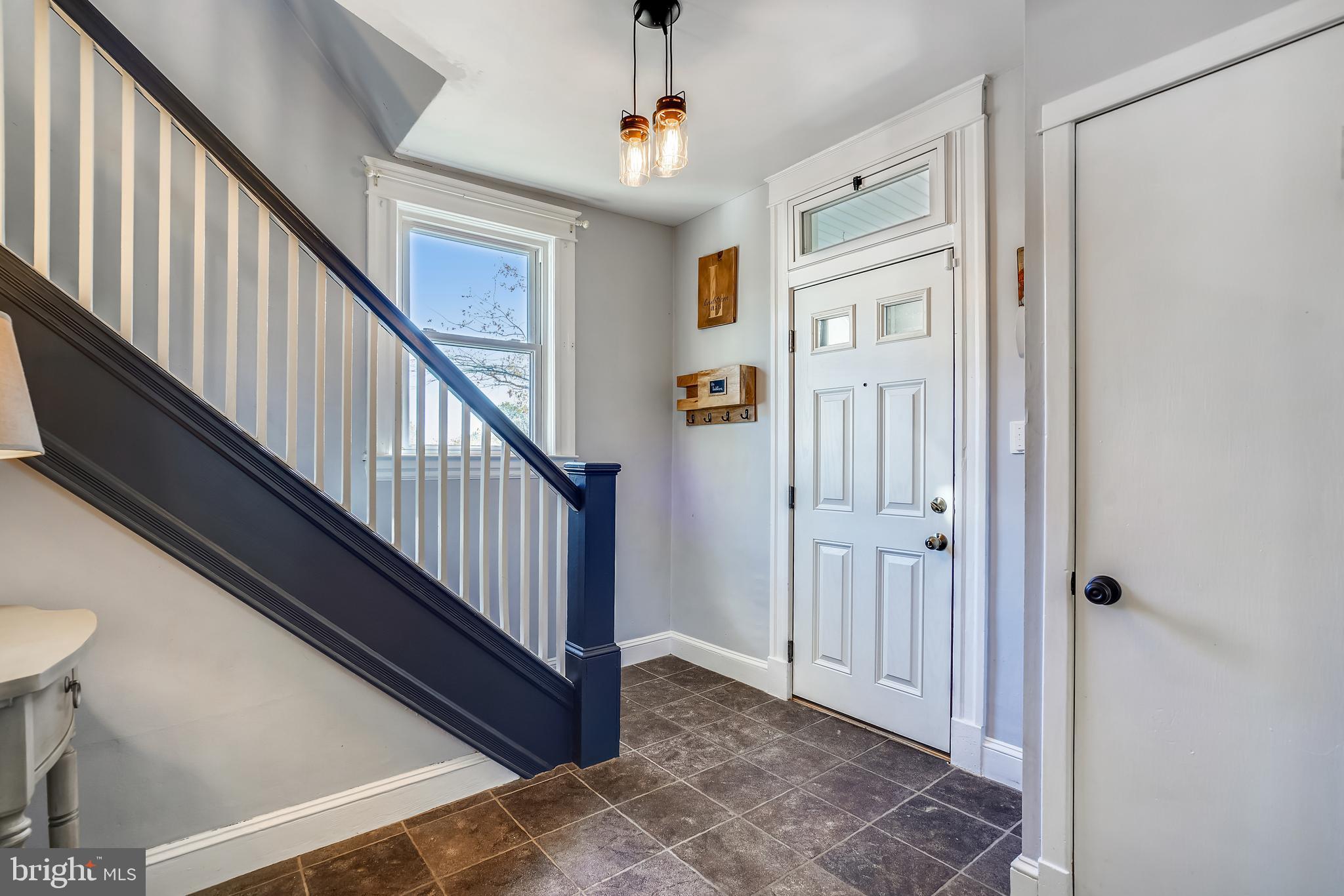 910 Overbrook Road Baltimore, MD 21239 - Photo 9 of 50 a view of a hallway with wooden floor and staircase