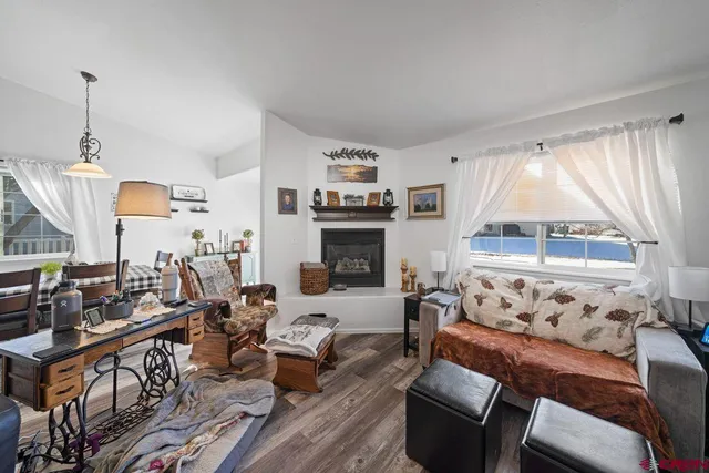 a living room with furniture a large window and a fireplace