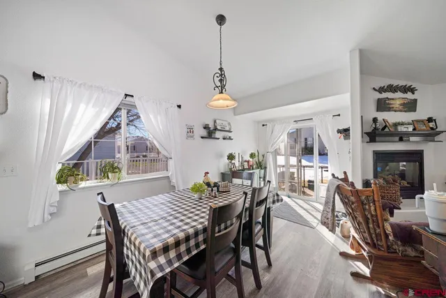 a view of a dining room with furniture window and wooden floor