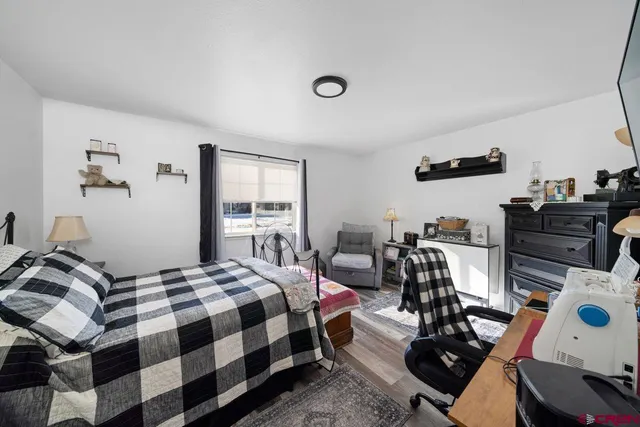 a bedroom with furniture and a flat screen tv