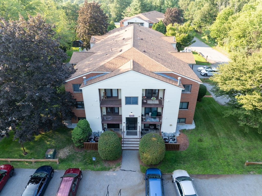 189 Littleton Road, Unit 10 Chelmsford, MA 01824 - Photo 14 of 15 a front view of house with a garden