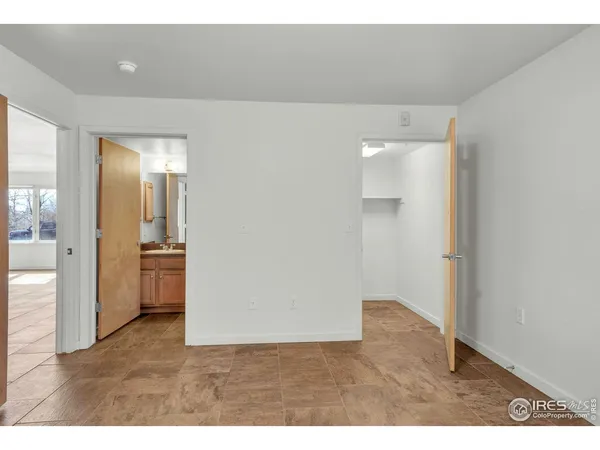 a bathroom with a bathtub shower sink vanity mirror and toilet