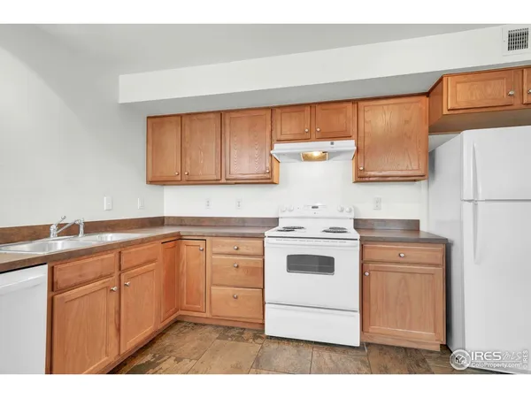 a kitchen with a stove a sink and a refrigerator