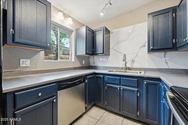 a kitchen with stainless steel appliances granite countertop a sink and cabinets