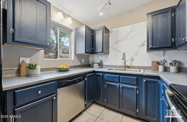 a kitchen with stainless steel appliances granite countertop a sink stove and cabinets