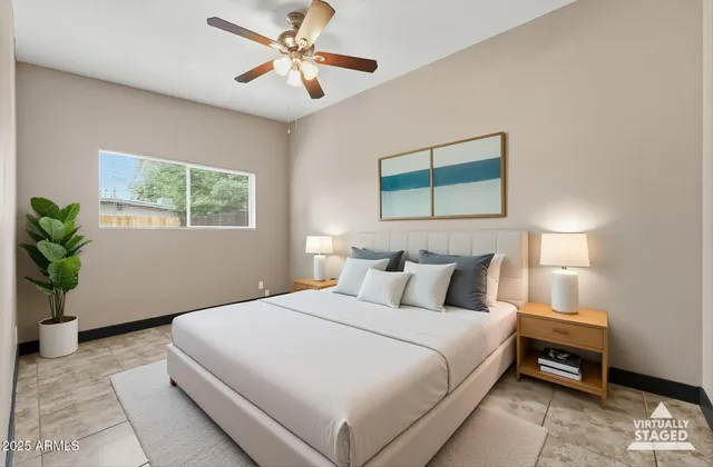 a bedroom with a bed and a painting on the wall