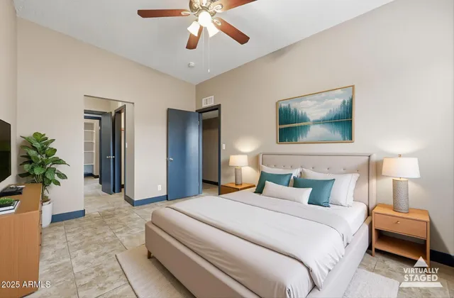 a bedroom with a bed and a chandelier