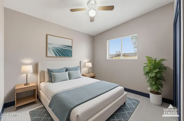 a bedroom with a large bed and a potted plant