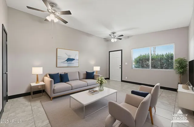 a living room with furniture a lamp and a window