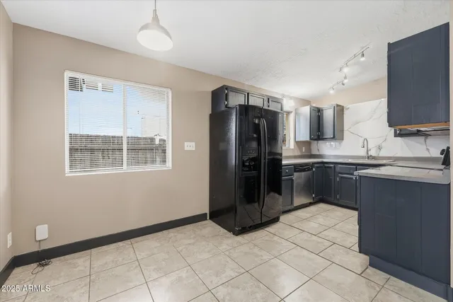 a kitchen with stainless steel appliances a refrigerator sink and microwave