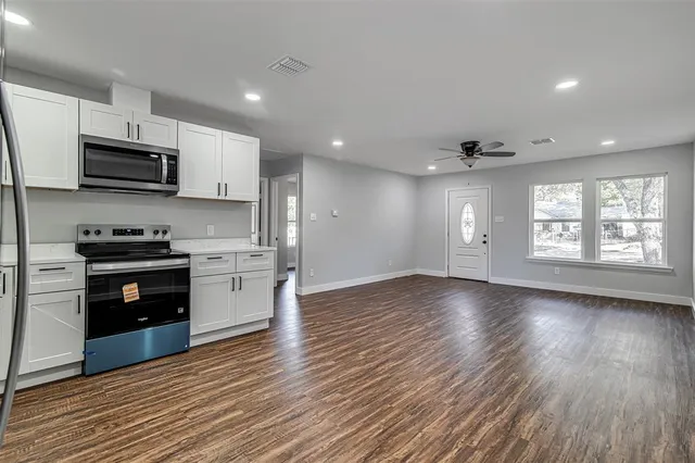 a kitchen with stainless steel appliances a refrigerator sink and stove