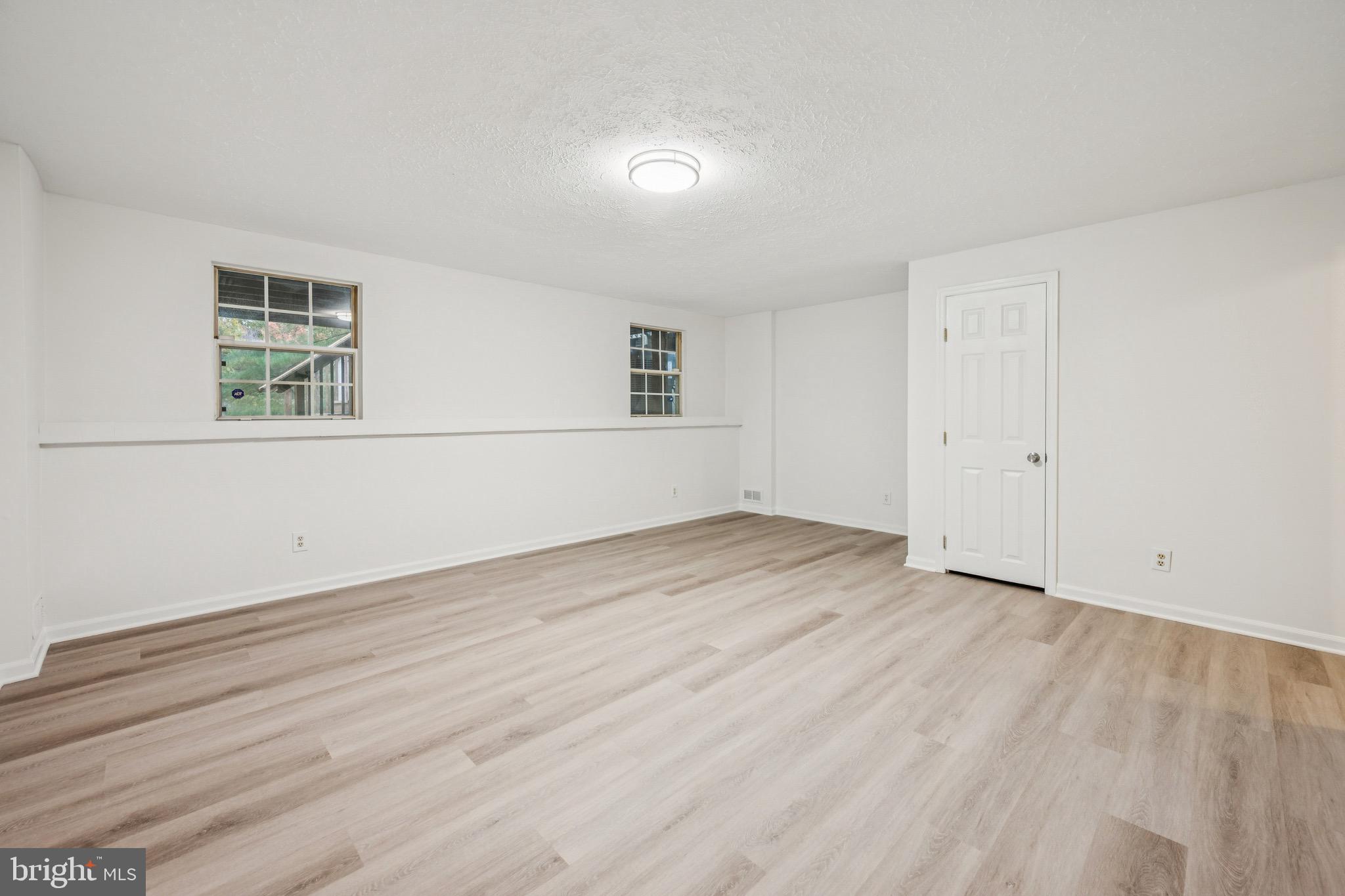 29 Wagon Wheel Drive Sicklerville, NJ 08081 - Photo 13 of 18 an empty room with wooden floor and windows