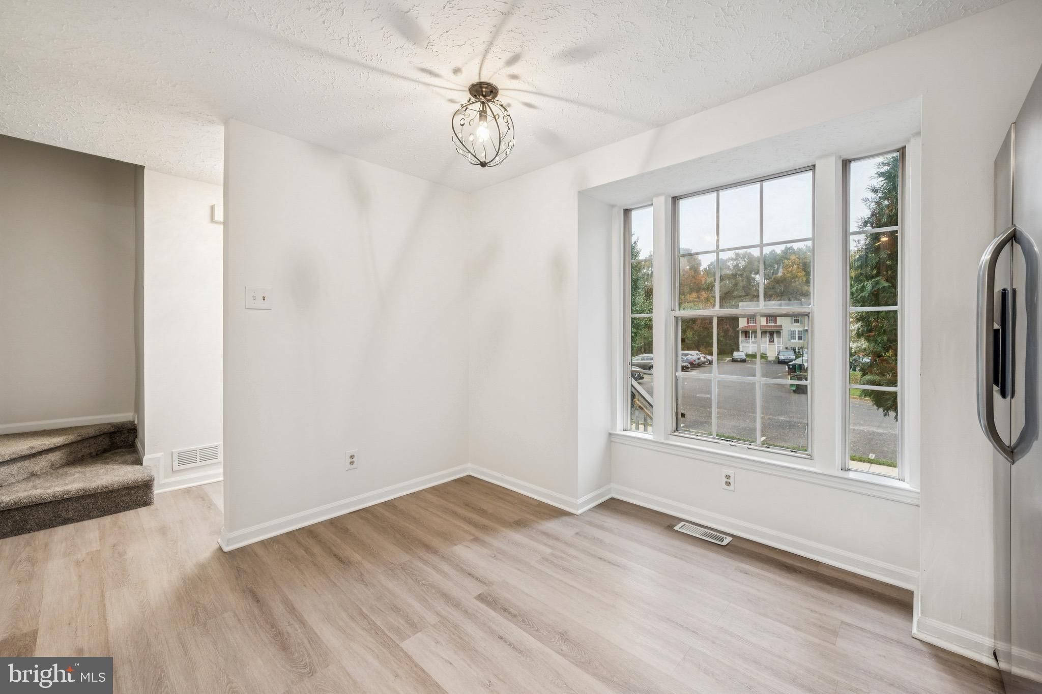 29 Wagon Wheel Drive Sicklerville, NJ 08081 - Photo 4 of 18 an empty room with wooden floor fan and windows