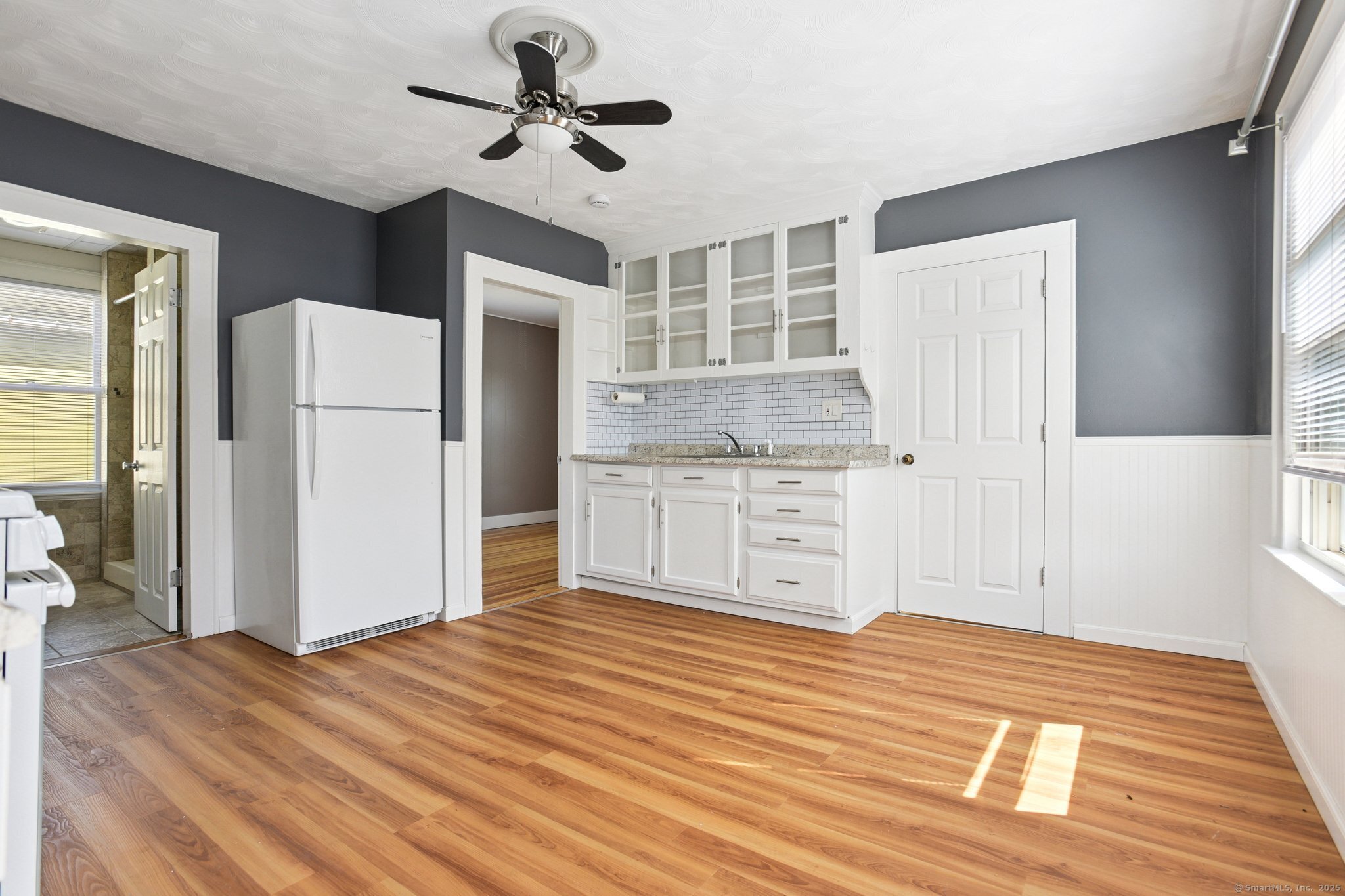 14 East Street, Unit 2 Wallingford, CT 06492 - Photo 3 of 6 a view of a kitchen with wooden floor and a ceiling fan