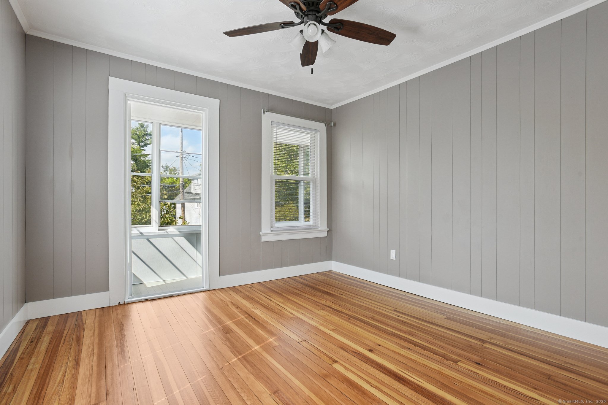 14 East Street, Unit 2 Wallingford, CT 06492 - Photo 6 of 6 a view of an empty room with wooden floor and a window