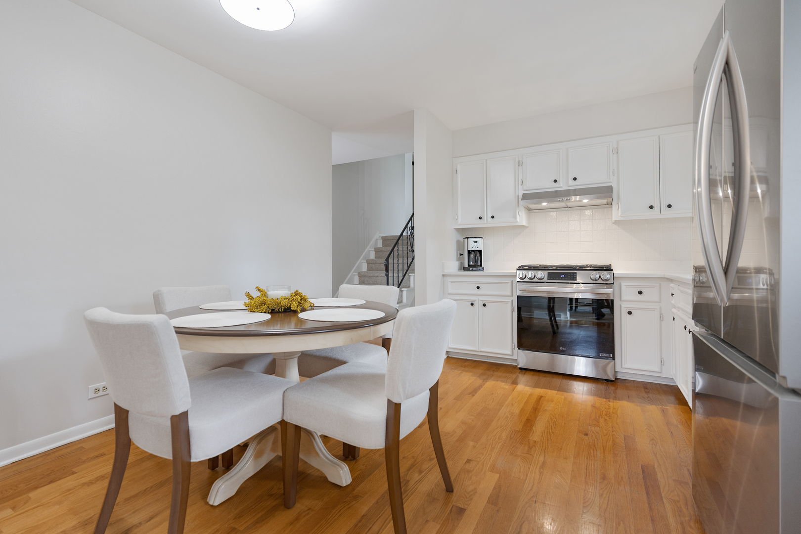 1827 West Sherry Lane Addison, IL 60101 - Photo 11 of 31 a kitchen with a stove a table and chairs in it