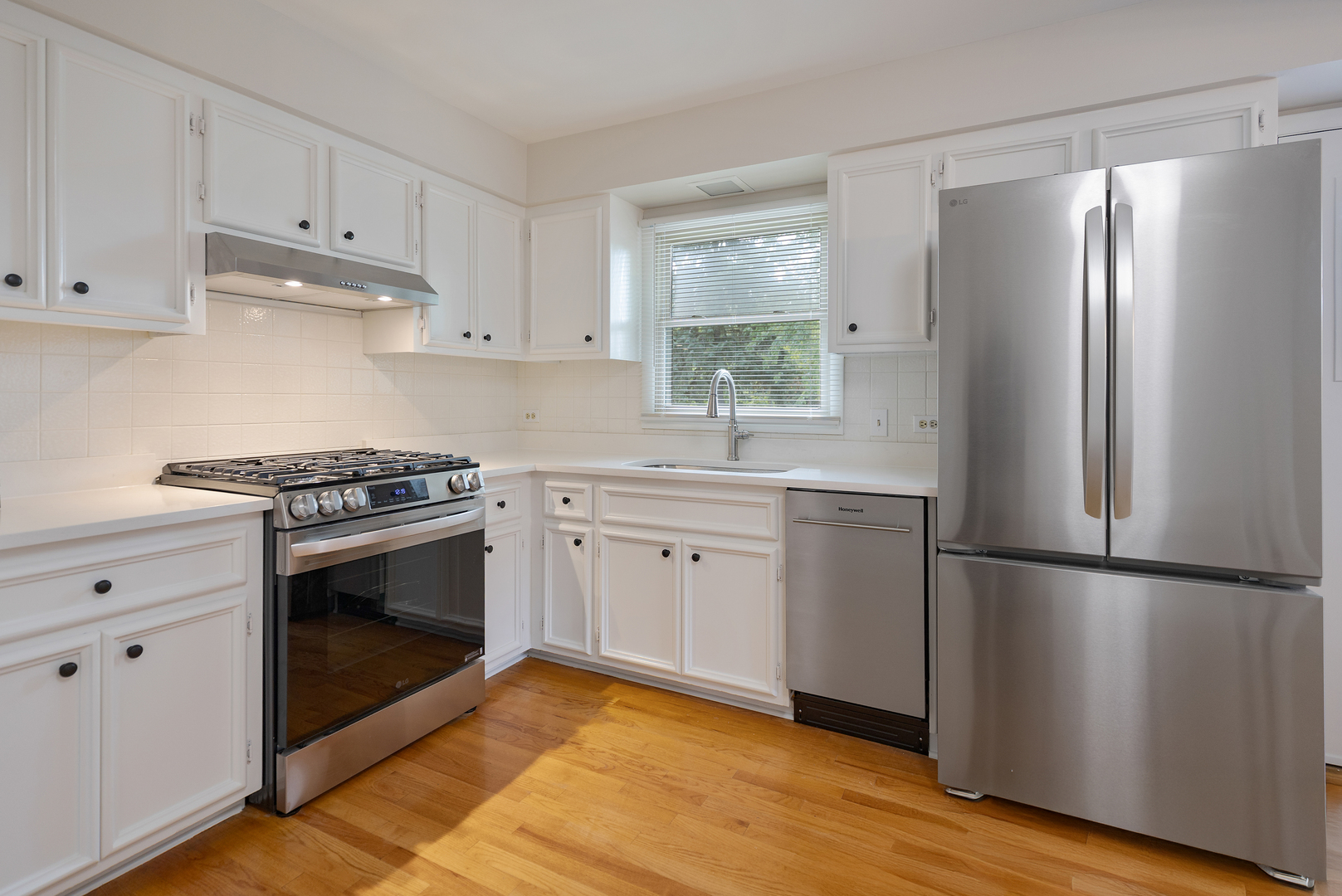 1827 West Sherry Lane Addison, IL 60101 - Photo 12 of 31 a kitchen with a refrigerator stove and white cabinets