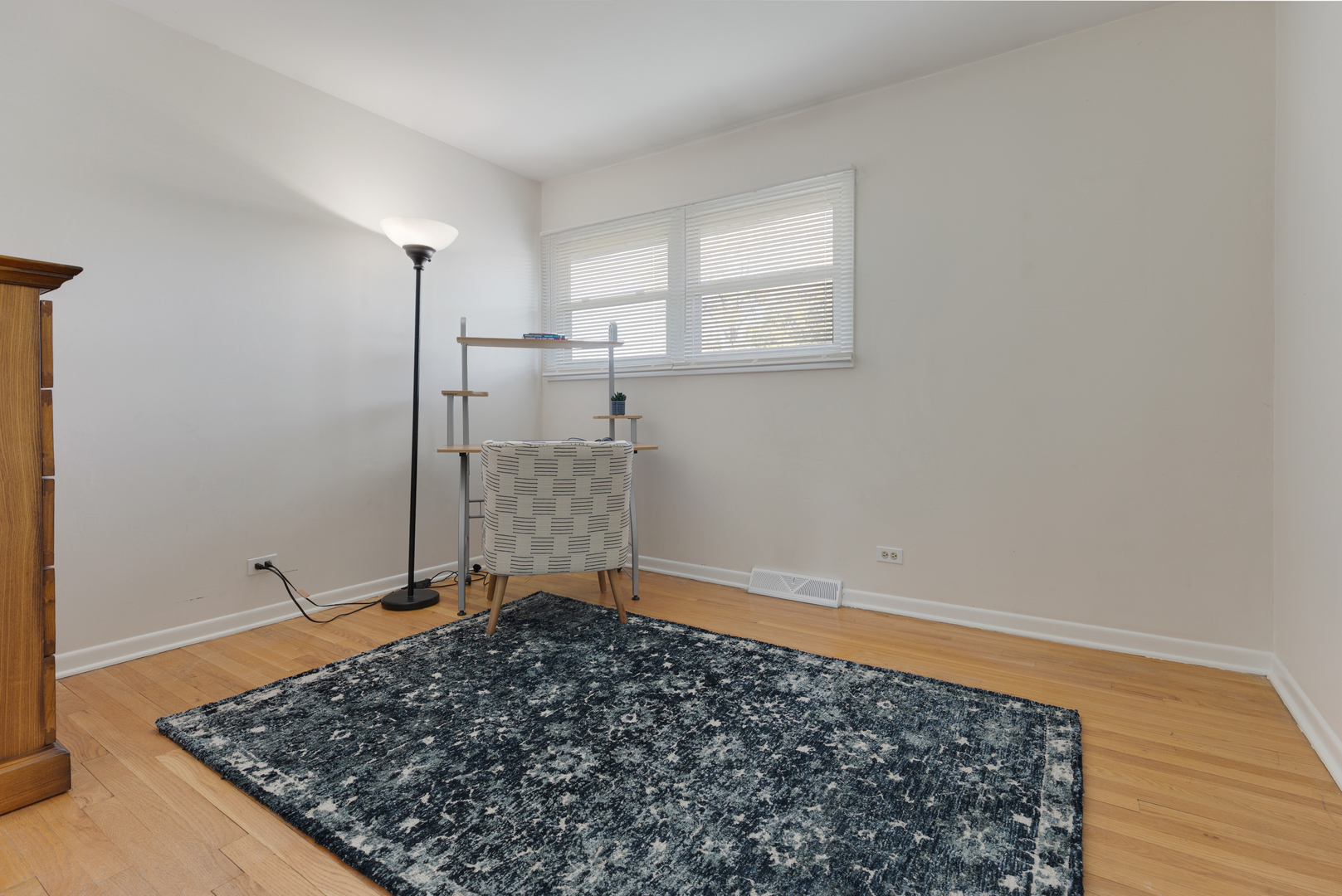 1827 West Sherry Lane Addison, IL 60101 - Photo 18 of 31 a view of a room with wooden floor and a rug