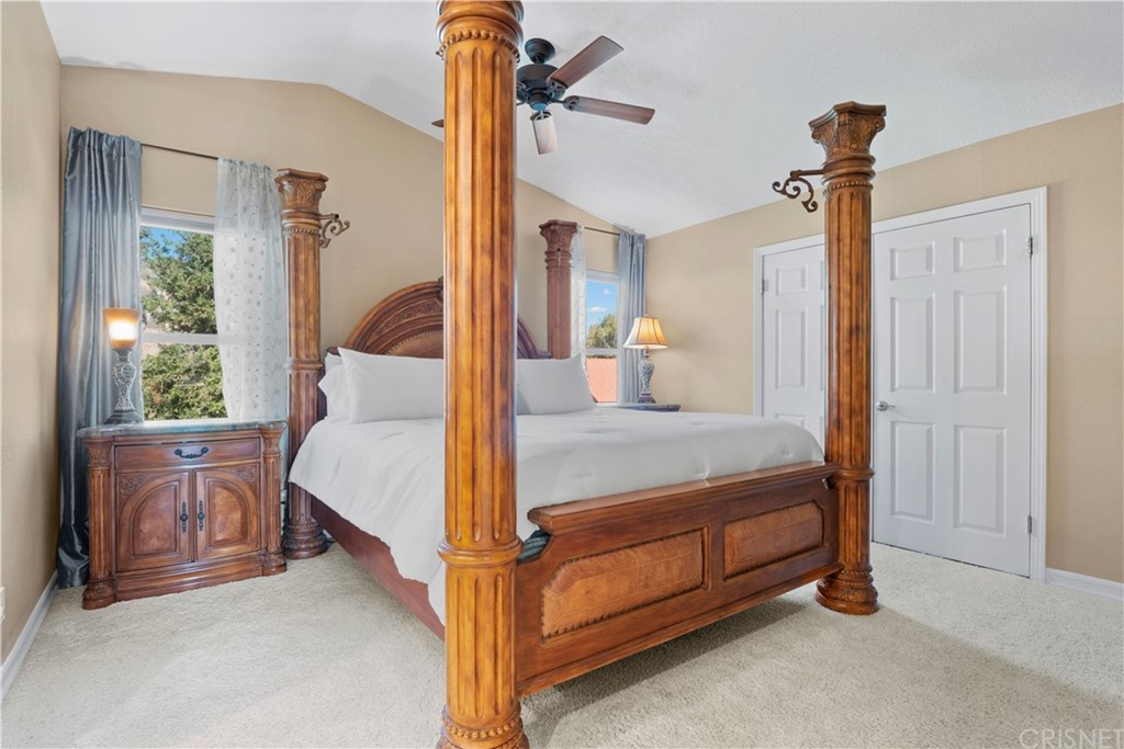 28043 Nantucket Street Castaic, CA 91384 - Photo 23 of 61 a bed room with a bed and a chandelier