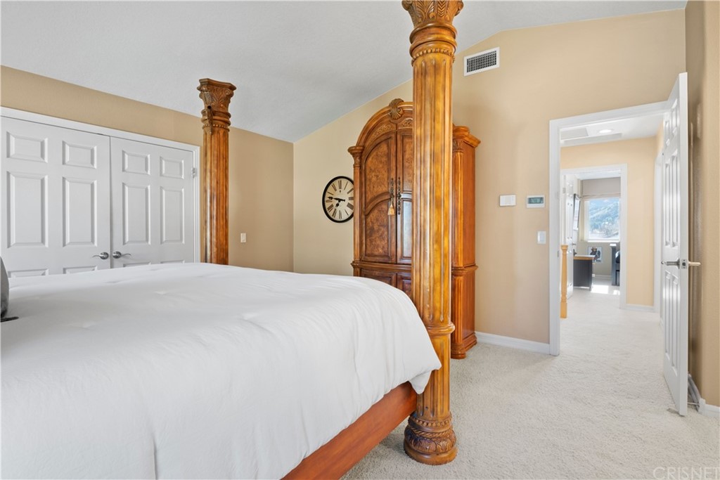 28043 Nantucket Street Castaic, CA 91384 - Photo 24 of 61 a bedroom with a bed and a chandelier