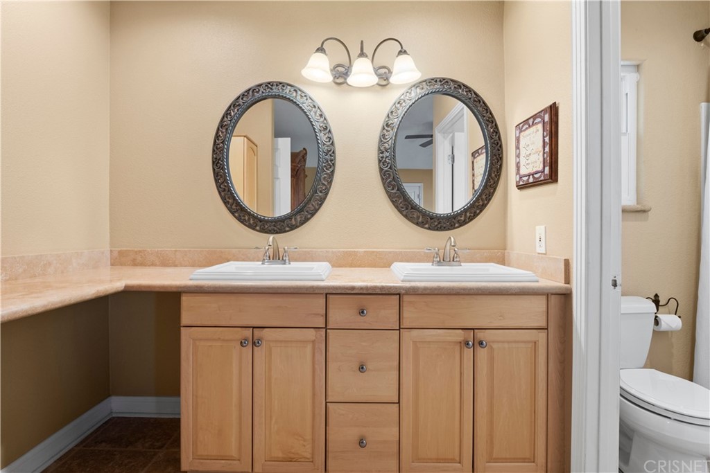 28043 Nantucket Street Castaic, CA 91384 - Photo 26 of 61 a bathroom with a sink and a mirror