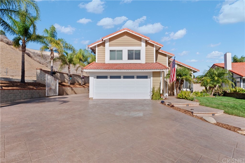 28043 Nantucket Street Castaic, CA 91384 - Photo 4 of 61 a front view of a house with a yard and garage