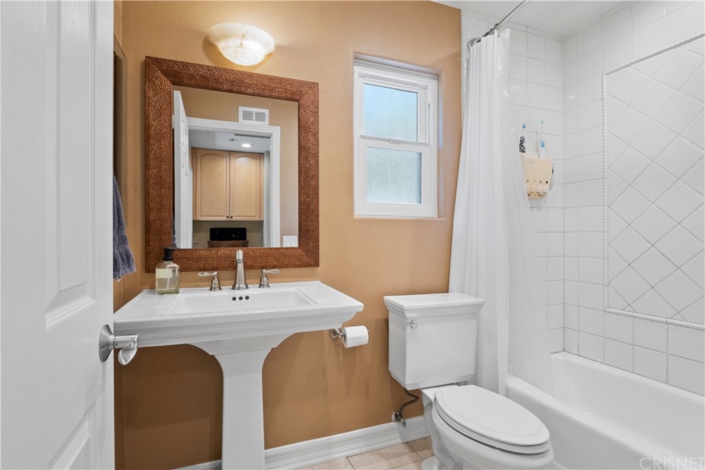 28043 Nantucket Street Castaic, CA 91384 - Photo 31 of 61 a bathroom with a sink a toilet a mirror and shower