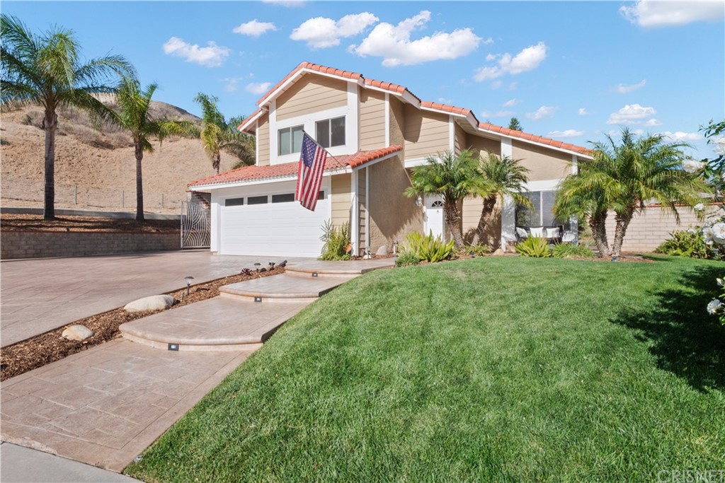 28043 Nantucket Street Castaic, CA 91384 - Photo 5 of 61 a front view of a house with a yard and potted plants