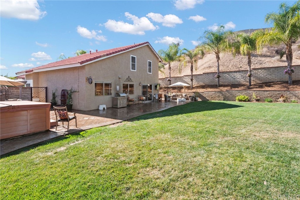 28043 Nantucket Street Castaic, CA 91384 - Photo 50 of 61 a view of a backyard with a sitting area and slide