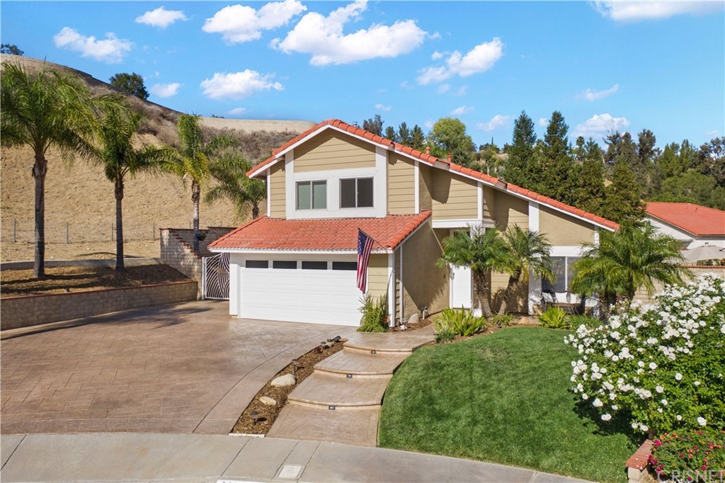 28043 Nantucket Street Castaic, CA 91384 - Photo 55 of 61 a front view of a house with a yard and potted plants