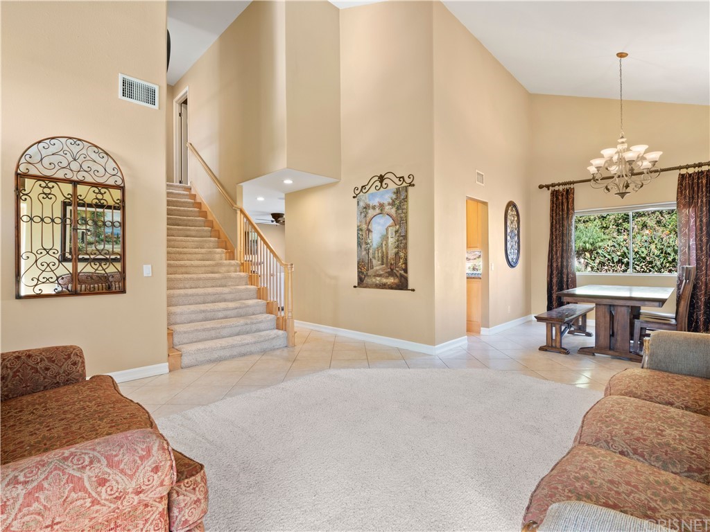 28043 Nantucket Street Castaic, CA 91384 - Photo 8 of 61 a living room with furniture and a chandelier