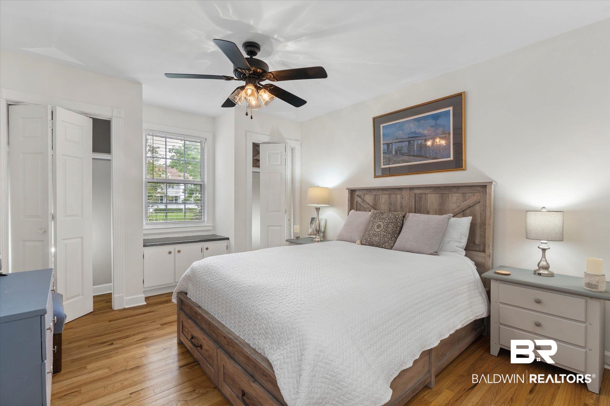 214 Upham Street, Unit 18A Mobile, AL 36607 - Photo 15 of 29 Bedroom with light wood-style floors, two closets, and a ceiling fan