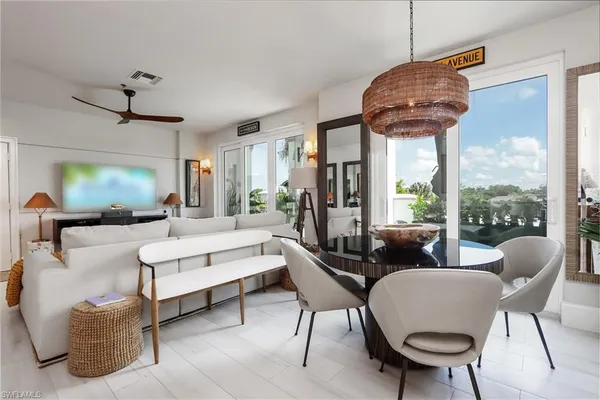 a living room with furniture a chandelier and a large window
