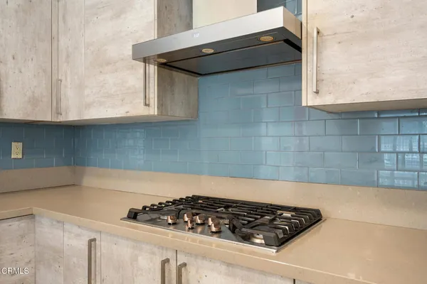 a kitchen with wooden cabinets and a stove top oven