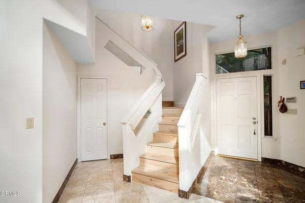 a view of entryway and hall with wooden floor